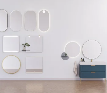 Modern showroom wall with backlit mirrors in varied shapes, a blue vanity with gold handles, wooden floor, and small shelves with a plant.